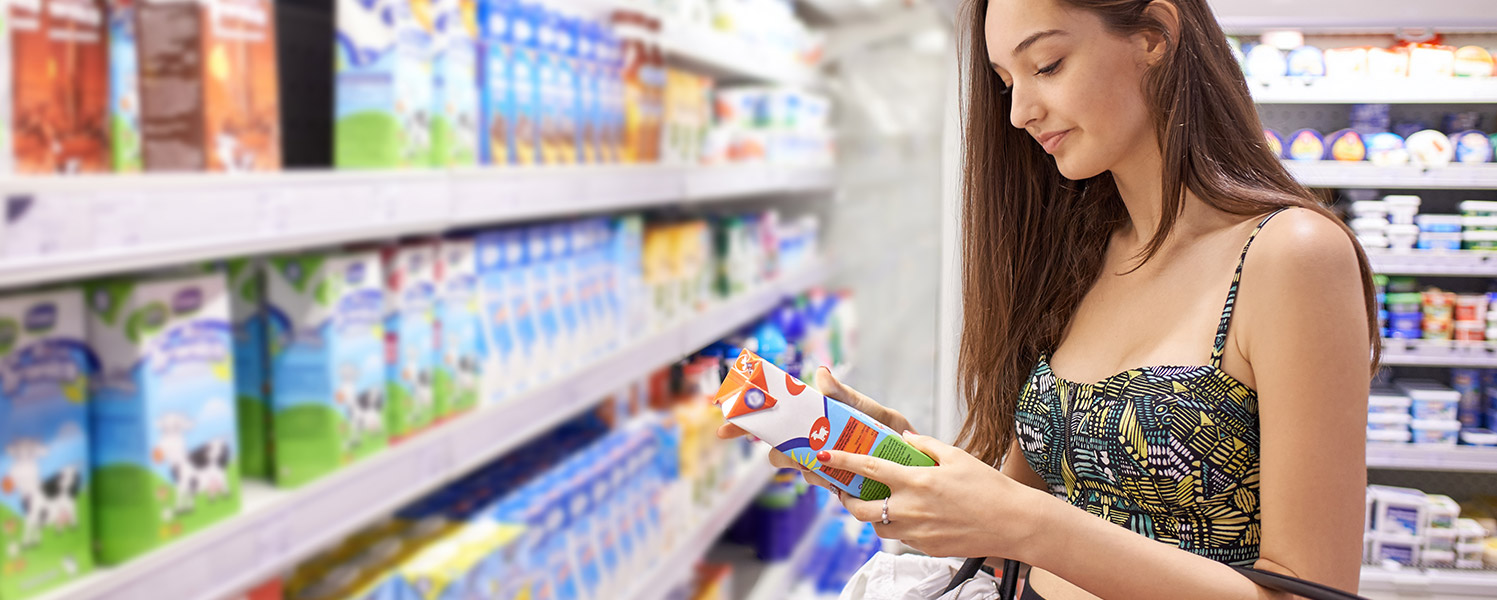 Woman in supermarket reading a product label