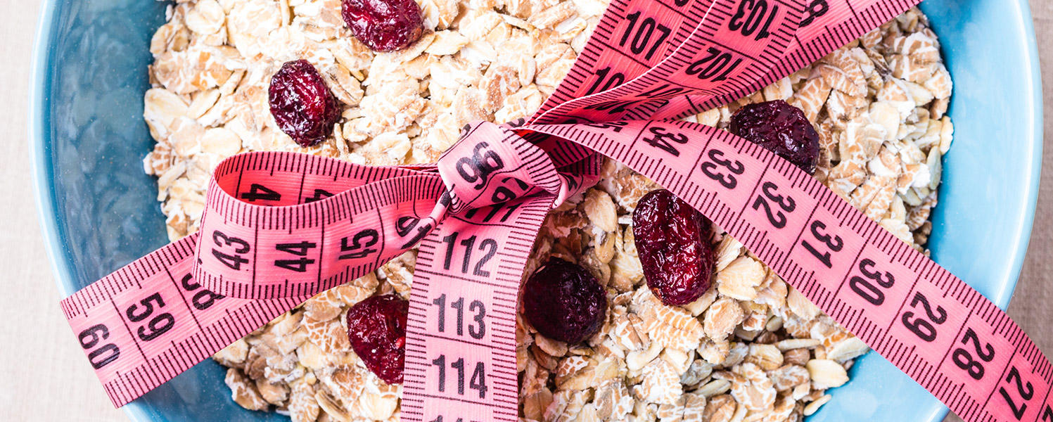 Pink measuring tape tied around a bowl of cereal