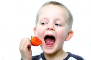 happy-boy-eating-strawberry.jpg