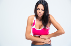 woman holding sore stomach