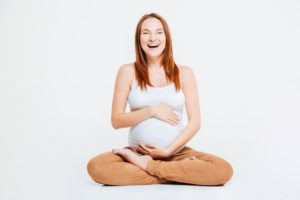 pregnant woman holding her stomach