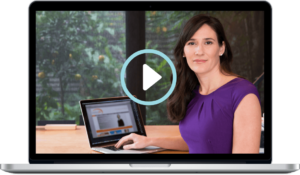Melanie McGrice sitting at a desk with a laptop