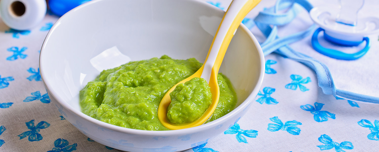 green baby food in a bowl