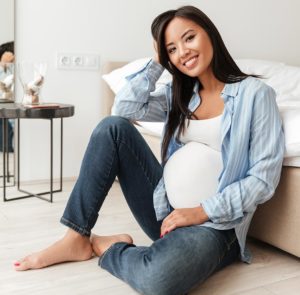 Pregnant woman sitting on the floor