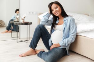 Pregnant woman sitting on the floor